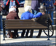 Ladies sat on bench with sculpture of Blind Jack