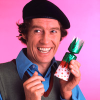 Frank Spencer holding a Christmas cracker