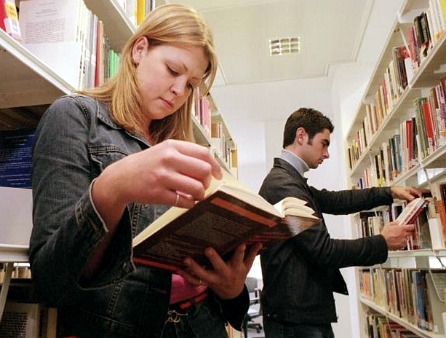 People looking at books in a library
