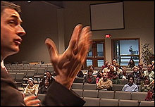 Justin addresses the meeting in Muskegon