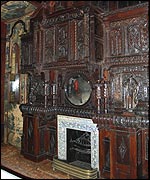 One of several ornate wooden fireplaces