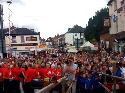 The crowd gather for the official raising of the Olympic flag in Upton-upon-Severn.