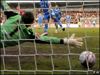 A football going into a goal