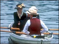 Three people in a rowing boat