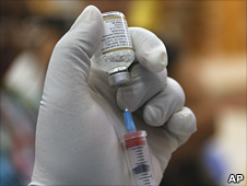 Nurse preparing swine flu vaccine