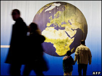 Passers-by look at the picture of the earth at the Technologies for Climate Protection exibition during the UN Climate Change Conference in Poznan, on December 7, 2008. WOJTEK RADWANSKI/AFP/Getty Images