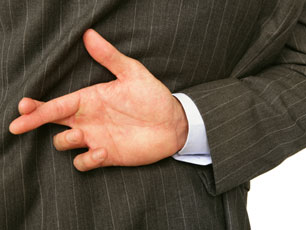 Fingers crossed behind a man's back (Image: Amanda Rohde/iStockphoto) Fingers crossed behind a man's back (Image: Amanda Rohde/iStockphoto)