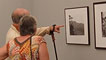 A couple looking at the Geoff Charles photography exhibition