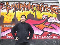 Ibrahim in front of the Islamic art mural