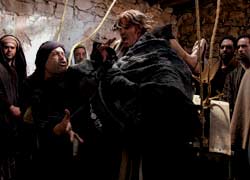 Jesus with a paralysed man who has been lowered from the ceiling