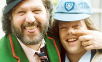 Former Radio 1 DJs Dave Lee Travis and Bruno Brookes dress up as paperboys. Don't ask why.