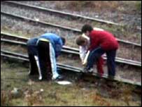 Group of children playing on the railway lines