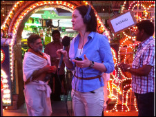 Reporter Madeleine Morris recording in a busy street