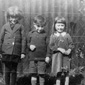 Smiling happy faces! Norman (centre) aged 4 with his sister Gretta and a friend