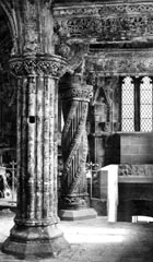 The plain, fluted Master Pillar in the foreground with the elaborately-carved Apprentice Pillar behind