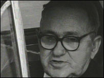 Man in glasses gives his view from his car