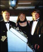 Janette and her husband Campbell on the Queen Mary 2 with Captain Warwick