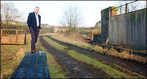 Alan Whitehouse stands on what remains of a railway bridge that served the route from Edinburgh to Carlisle but which was closed under the Beeching cuts in 1969. Campaigners still hope to have the line reopened.