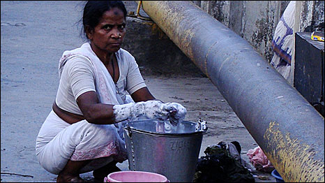 Woman washing clothes in the Hooghly river in Kolkata