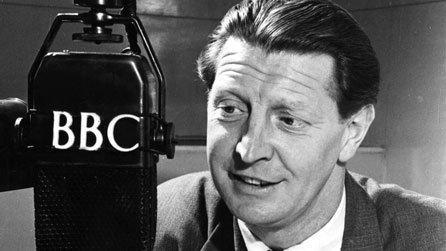 Black and white photograph of Roger Livesey with a BBC microphone in 1947