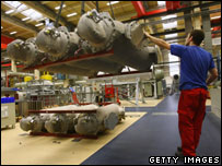 BERLIN - DECEMBER 15 2008: A worker moves parts for high-voltage circuit breakers at a factory of German engineering company Siemens on December 15, 2008 in Berlin, Germany. Sean Gallup/Getty Images
