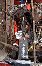 A jumble of different materials, including an anvil, sticks, a figurine and painted symbols