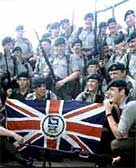 Image of British Army grouped around the Union Jack in 1982