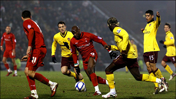 Jonathan Tehoue moves away from a posse of Arsenal defenders
