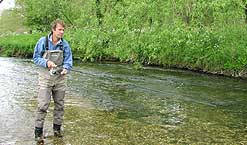 Barbel fisherman, John Bailey wading in a chalk stream