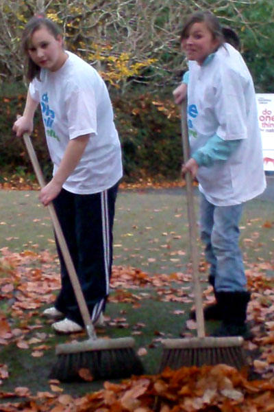 Two girls raking