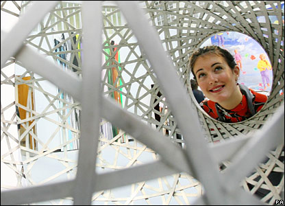 Christie's press officer Zoe School looks through a work by Danish artist Olafur Eliasson 