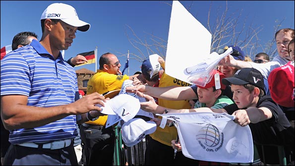 Tiger Woods signs autographs