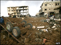 Palestinians search through the rubble of their buildings destroyed during Isreali strikes near the Rafah border in the southern Gaza Strip, on January 18, 2009