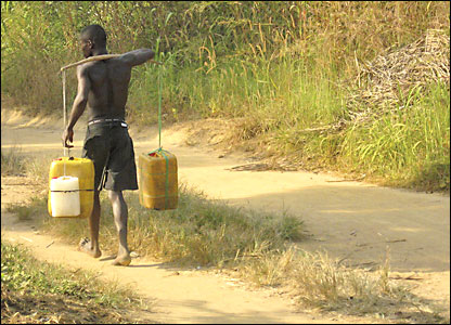 A palm wine tapper returns from the forests of Joe Town after a long day's work