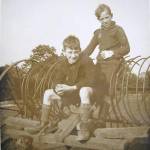 Two of the evacuees, one is sitting on the hay rake.