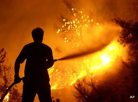 Firefighters putting out a blaze in Greece
