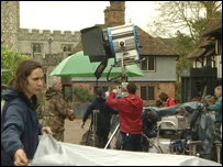 The film crew get ready in the village square
