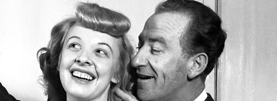 A man telling a woman a secret