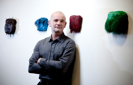 Paul Emmanuel with examples of his work