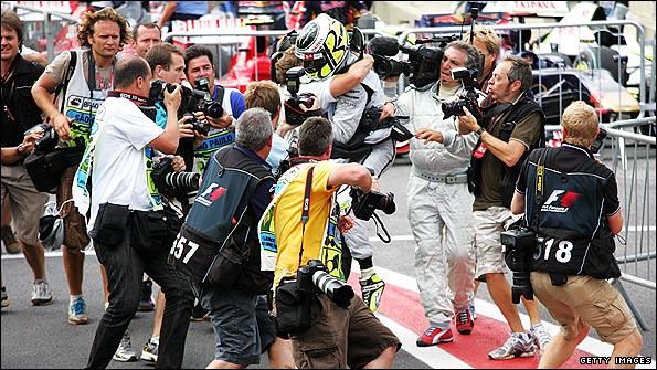 Brawn's Jenson Button is surrounded by photographers after clinching the 2009 world title