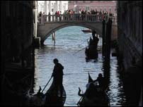 Gondolas under a bridge