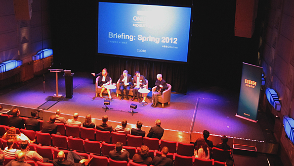 Picture of four people on the Radio Theatre stage