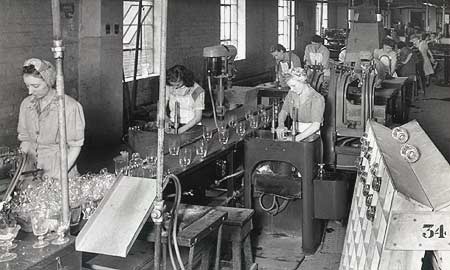 Workers cracking off and grinding glass