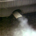 Close-up of a car's exhaust, belching fumes
