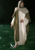 Jesus walking across the surface of a lake at night