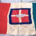 The Italian flag captured in Libya on November 21st 1942 by a detachment of the 8th Army and signed by them. George Cosmo McCallam won the lot to keep the flag.