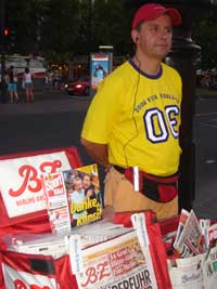 A man at his paper kiosk