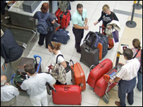 Lots of people at an airport check in desk