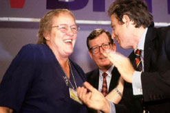 Accompanied by David Trimble And Tony Blair, Mo Mowlam receives a standing ovation at the 1999 Labour Party Conference