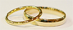 a pair of golden wedding rings